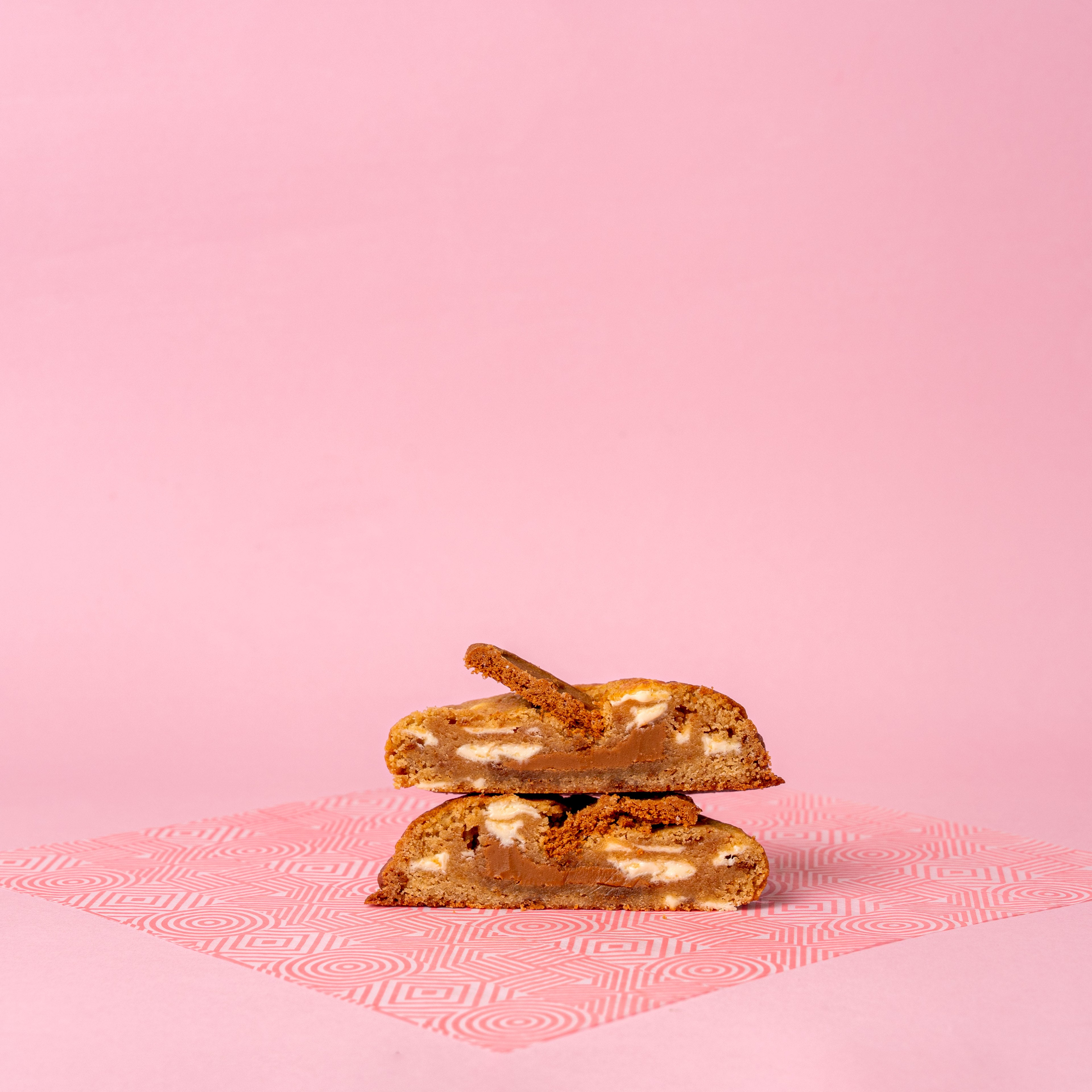 A Coco Lane cookie pulled apart showing the gooey melt-in-the-middle centre