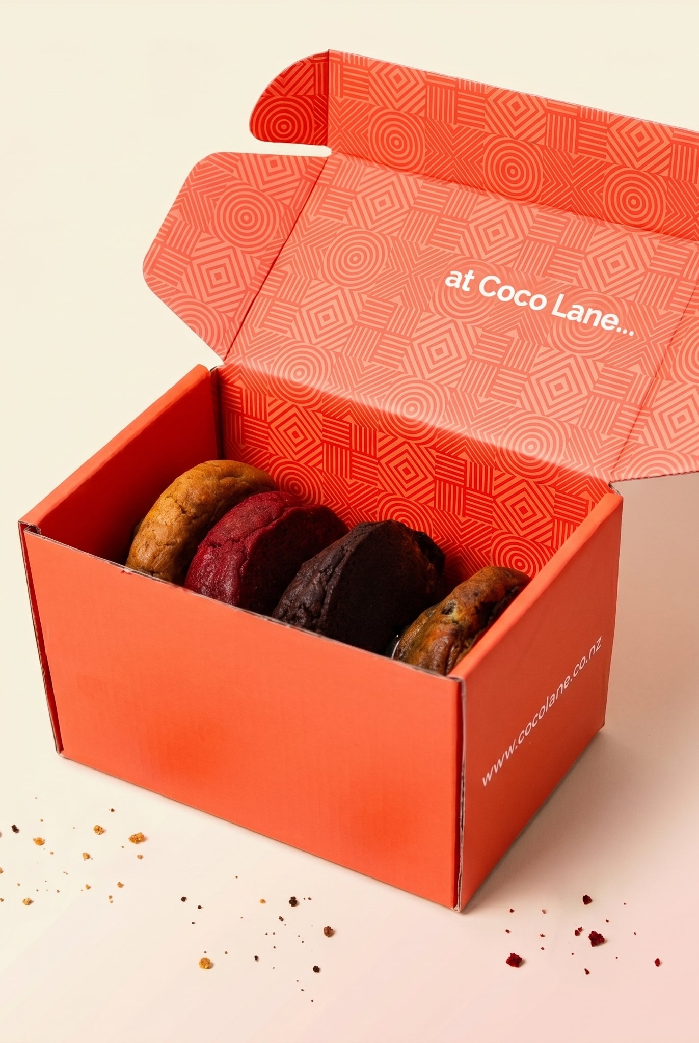 The Four Pack — four loaded cookies in the Coco Lane box, studio shot