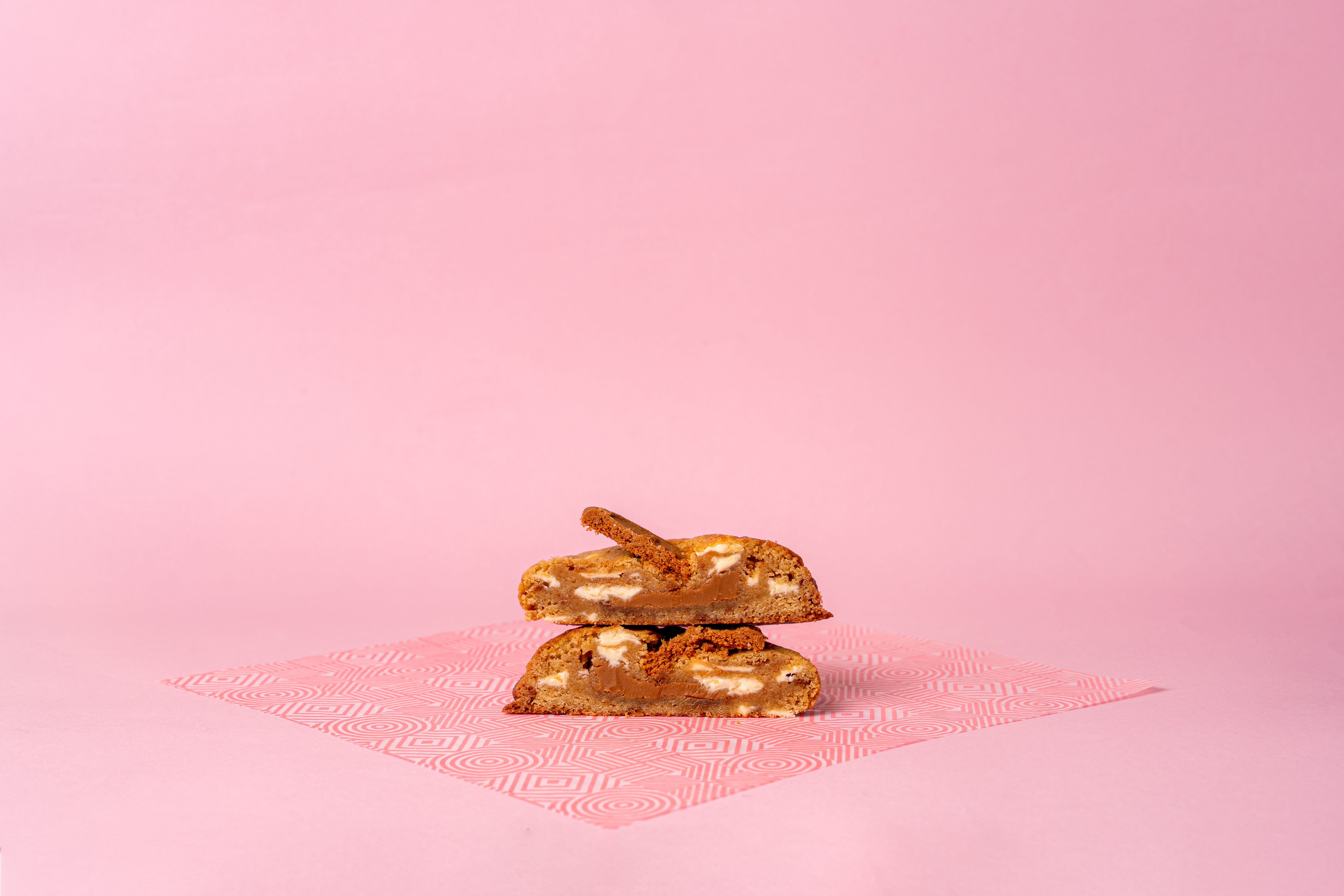 A Coco Lane cookie pulled apart showing the gooey melt-in-the-middle centre